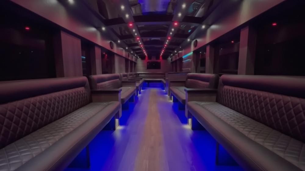 Spacious limousine interior with ambient blue and red lighting